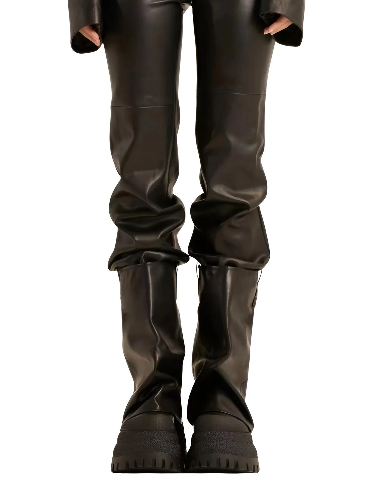 Black leather pants and black platform slouch boots on a white background