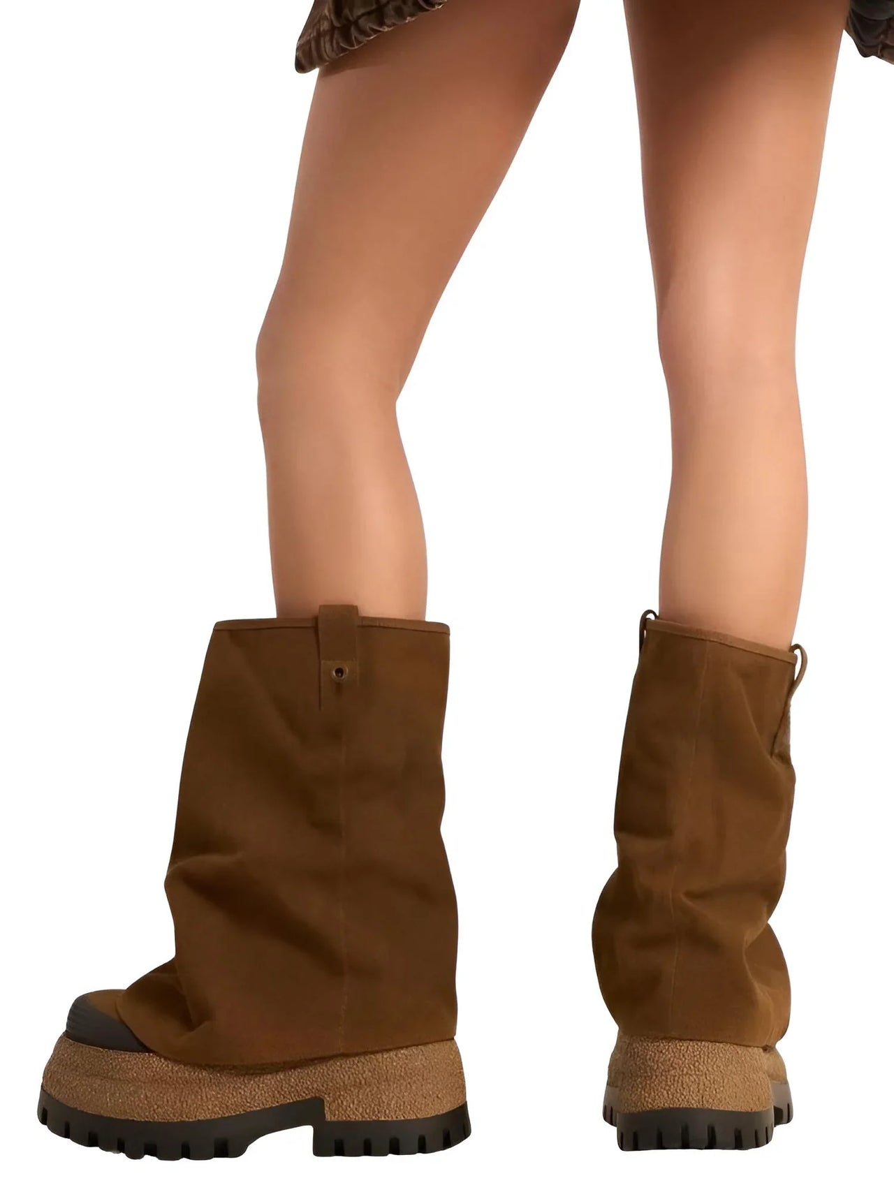 Brown platform slouch boots worn by a woman on a white background