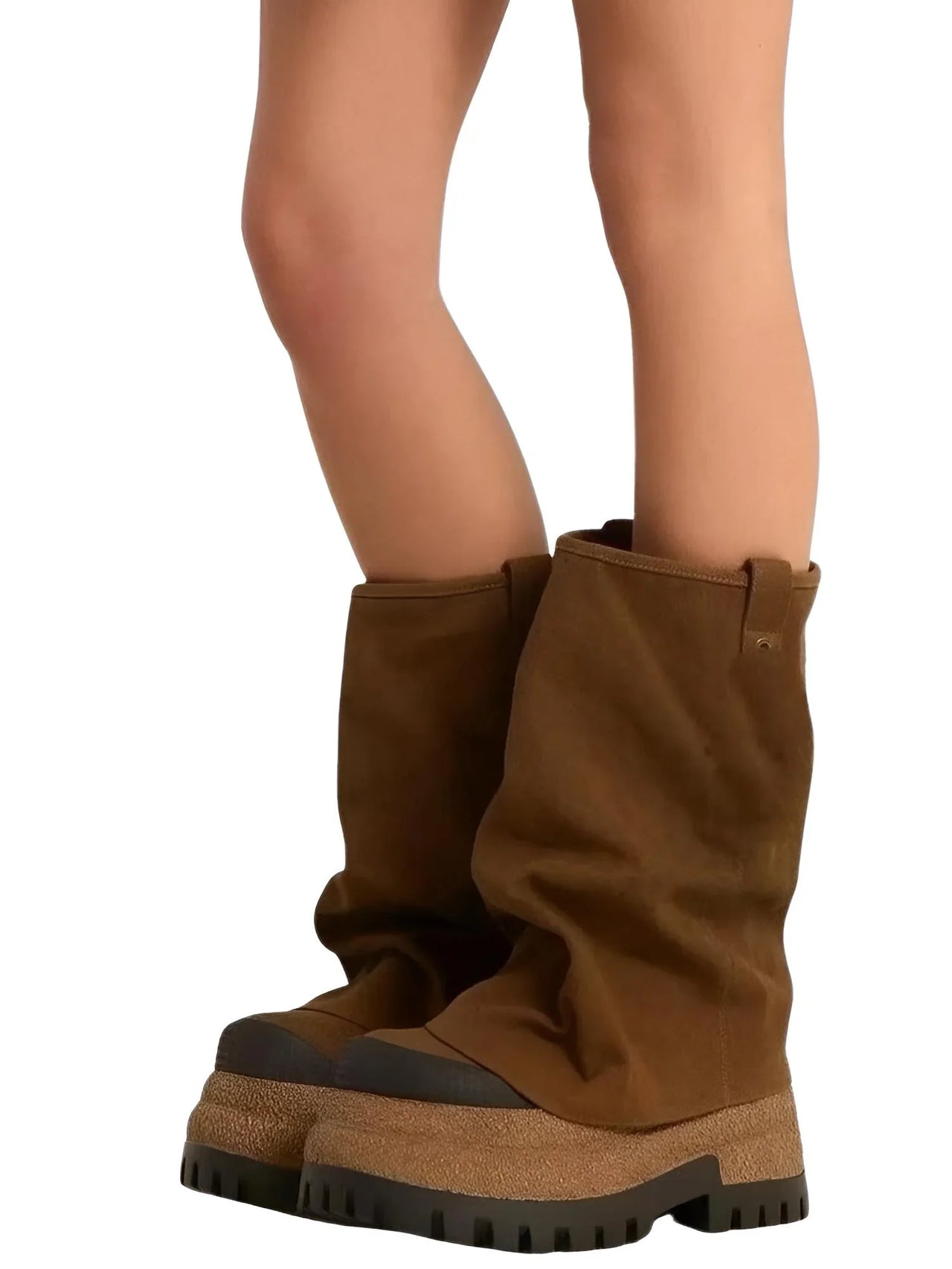 Brown suede platform slouch boots worn by a person on a white background