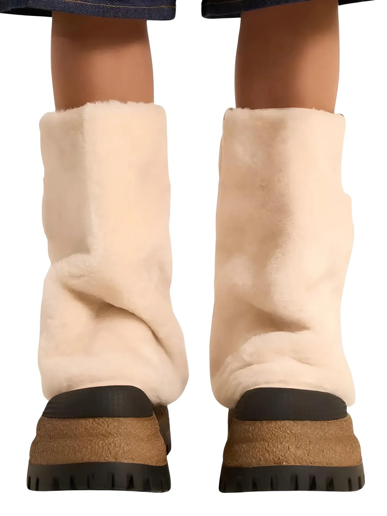 Woman wearing a pair of milk white platform slouch boots with black soles on a white background