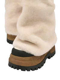 Thumbnail for Pair of milk white platform slouch boots with black soles on a white background