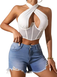 Thumbnail for Woman wearing a white halter top and blue denim shorts on a white background