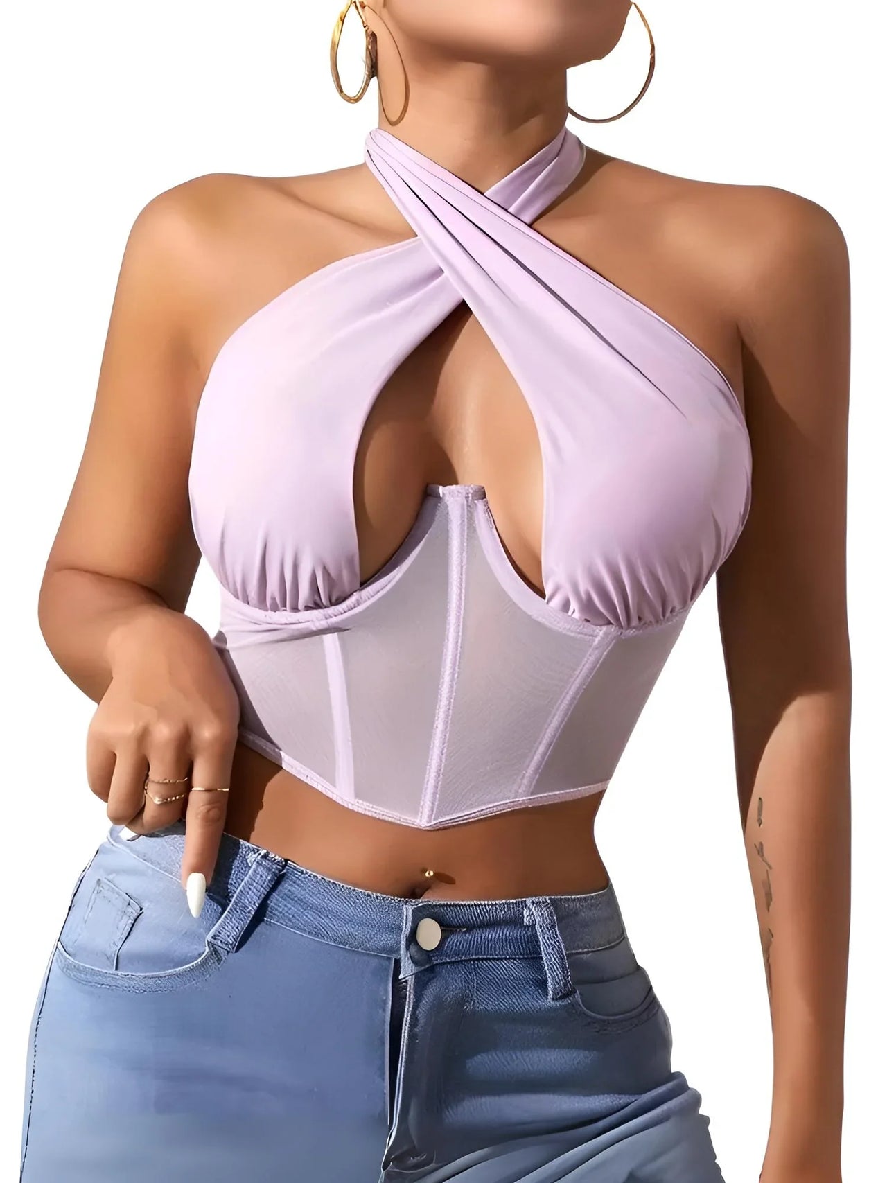 Woman wearing a light purple halter top with mesh panels and blue jeans on a white background