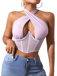 Thumbnail for Woman wearing a light purple halter top with mesh panels and blue jeans on a white background
