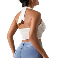 Thumbnail for Woman wearing a white halter top and blue jeans on a white background