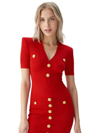 Thumbnail for Woman wearing a red dress with gold buttons on a white background