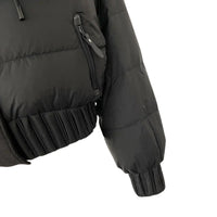 Thumbnail for Black puffer jacket with ruffled hem on a white background