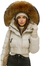 Thumbnail for Woman wearing a cream puffer jacket with a large fur hood on a white background