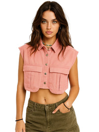 Thumbnail for Woman wearing a pink sleeveless top with green pants on a white background