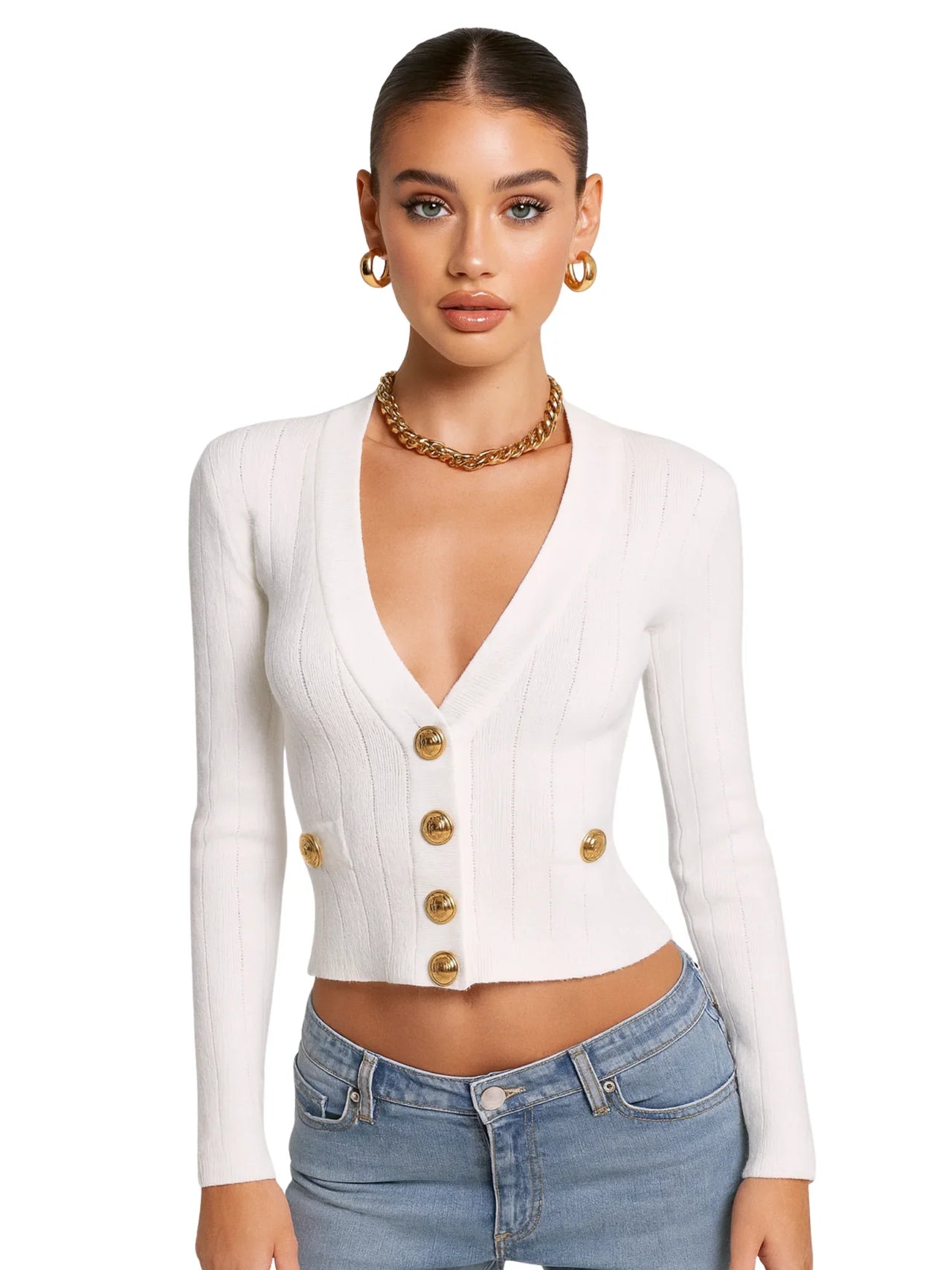Woman wearing a white cardigan with gold buttons and blue jeans on a white background
