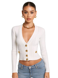 Thumbnail for Woman wearing a white cardigan with gold buttons and blue jeans on a white background