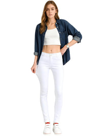Thumbnail for Woman wearing a denim shirt, white crop top, and white skinny jeans on a white background