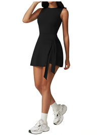 Thumbnail for Person wearing a black sleeveless dress with a tie waist on a white background