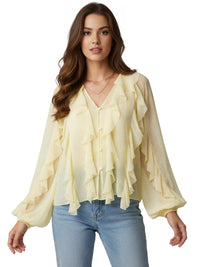 Thumbnail for Woman wearing a light yellow ruffled blouse and blue jeans on a white background