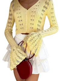 Thumbnail for Woman wearing a yellow flare sleeve cardigan and white skirt with a red handbag on a white background