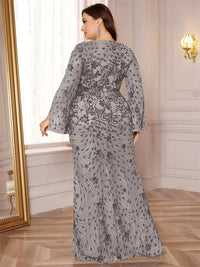 Thumbnail for Woman wearing a gray floral maxi dress in an elegant room with a mirror and light fixture.