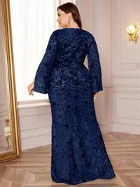 Thumbnail for Woman wearing a navy blue sequin dress in a room with a mirror and light fixture.