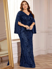 Thumbnail for Woman in a navy blue sequin dress standing in a room with a mirror.