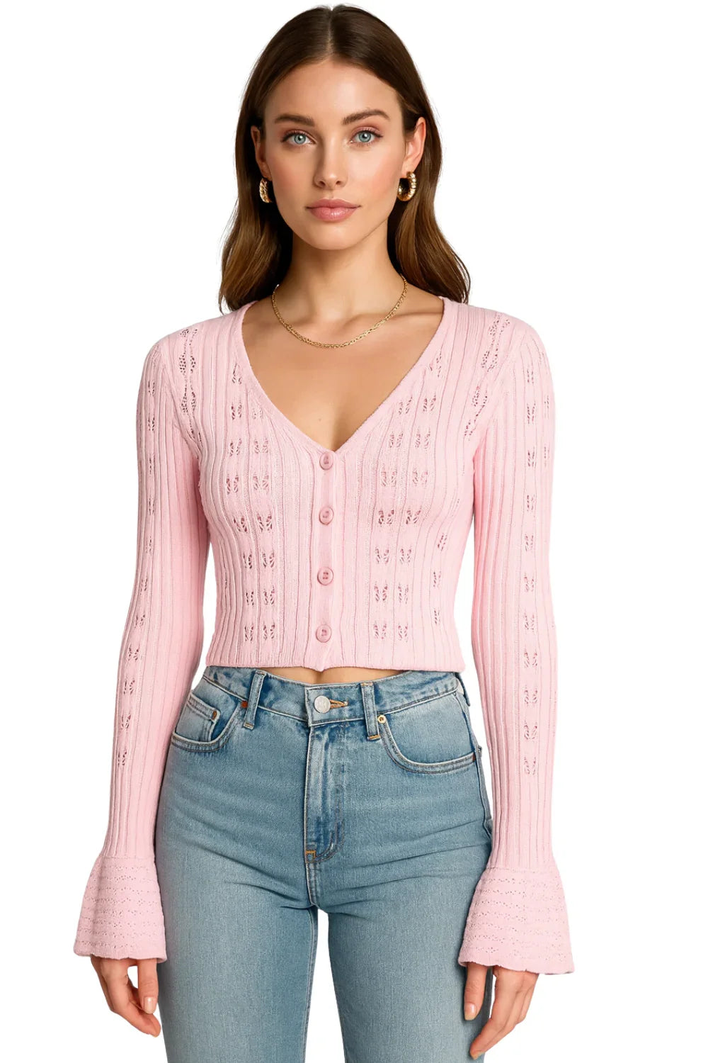 Woman wearing a pink cropped cardigan sweater and blue jeans on a white background