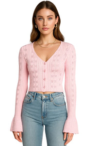 Thumbnail for Woman wearing a pink cropped cardigan sweater and blue jeans on a white background