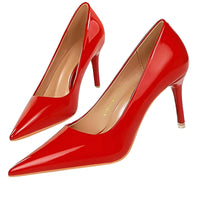 Thumbnail for Pair of red high-heeled shoes on a white background