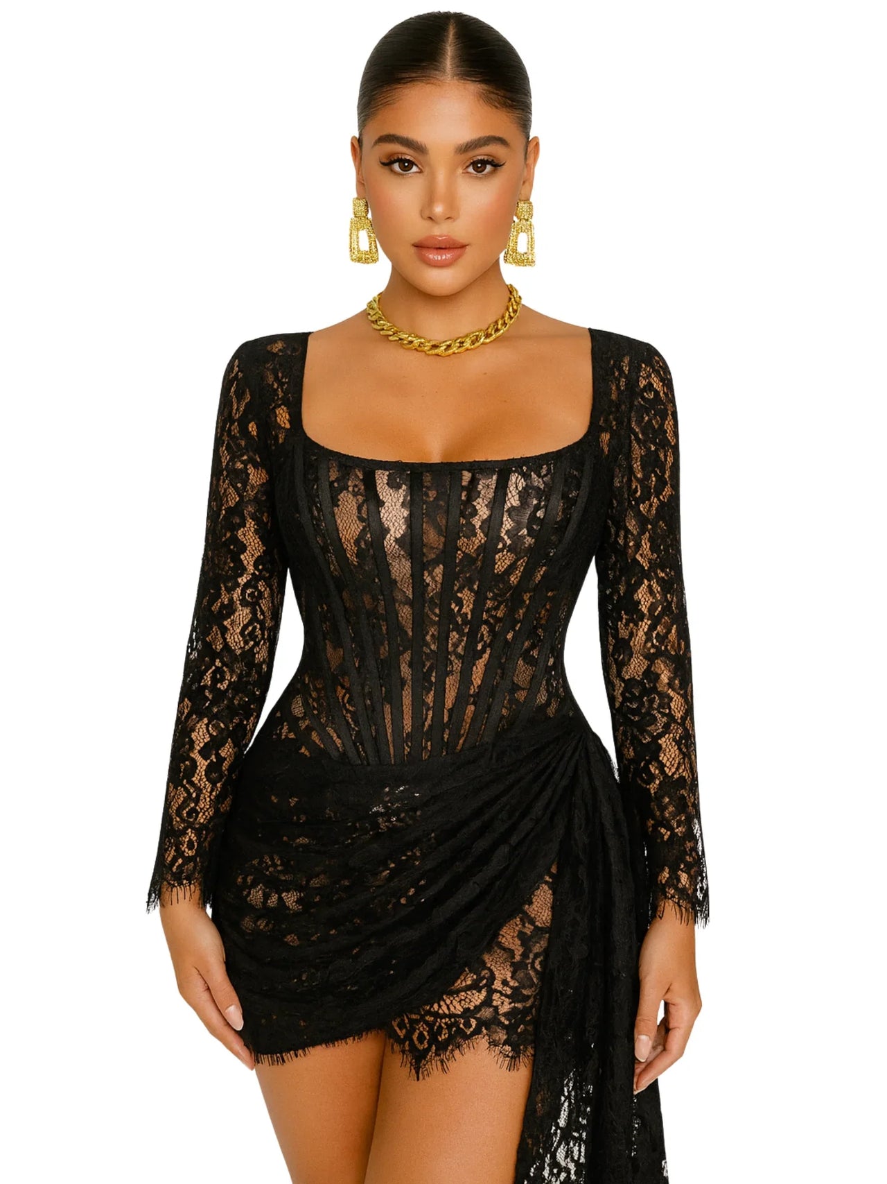 Woman wearing a black lace dress with long sleeves and gold jewelry on a white background