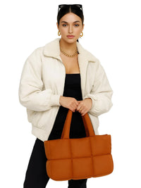 Thumbnail for Woman holding a brown puffer bag against a white background