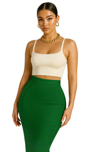 Thumbnail for Woman wearing a beige top and green pencil skirt on a white background