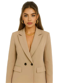 Thumbnail for Woman wearing a khaki blazer with gold jewelry on a white background
