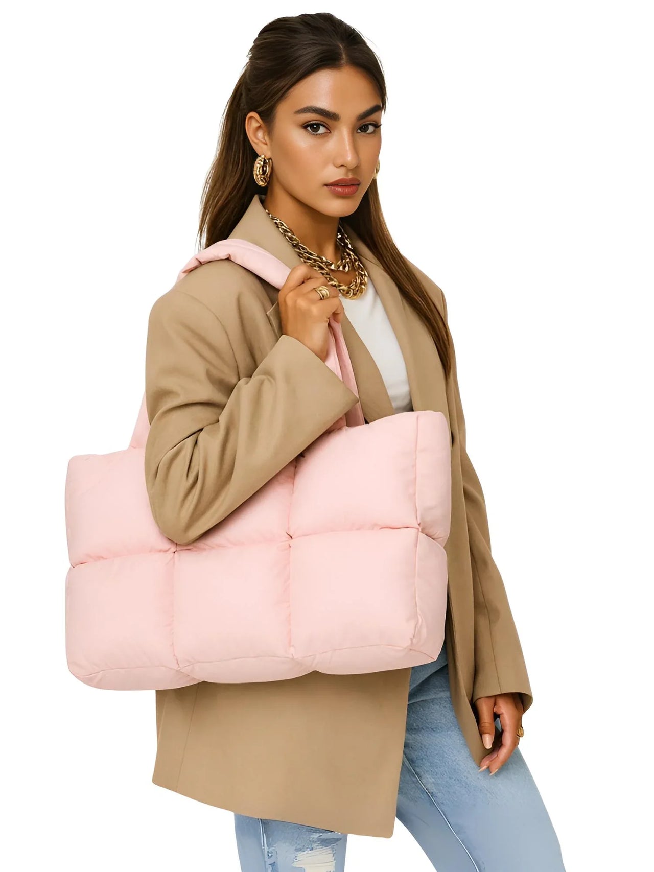 Woman holding a pink puffer bag against a white background