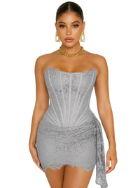 Thumbnail for Woman wearing a strapless gray lace dress with gold jewelry on a white background