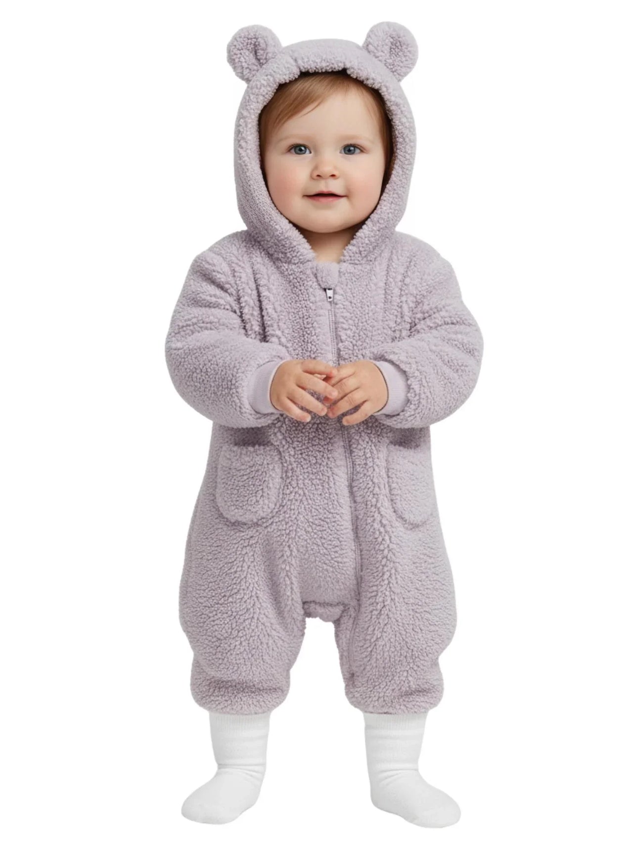 Baby wearing a fluffy purple onesie with bear ears on a white background
