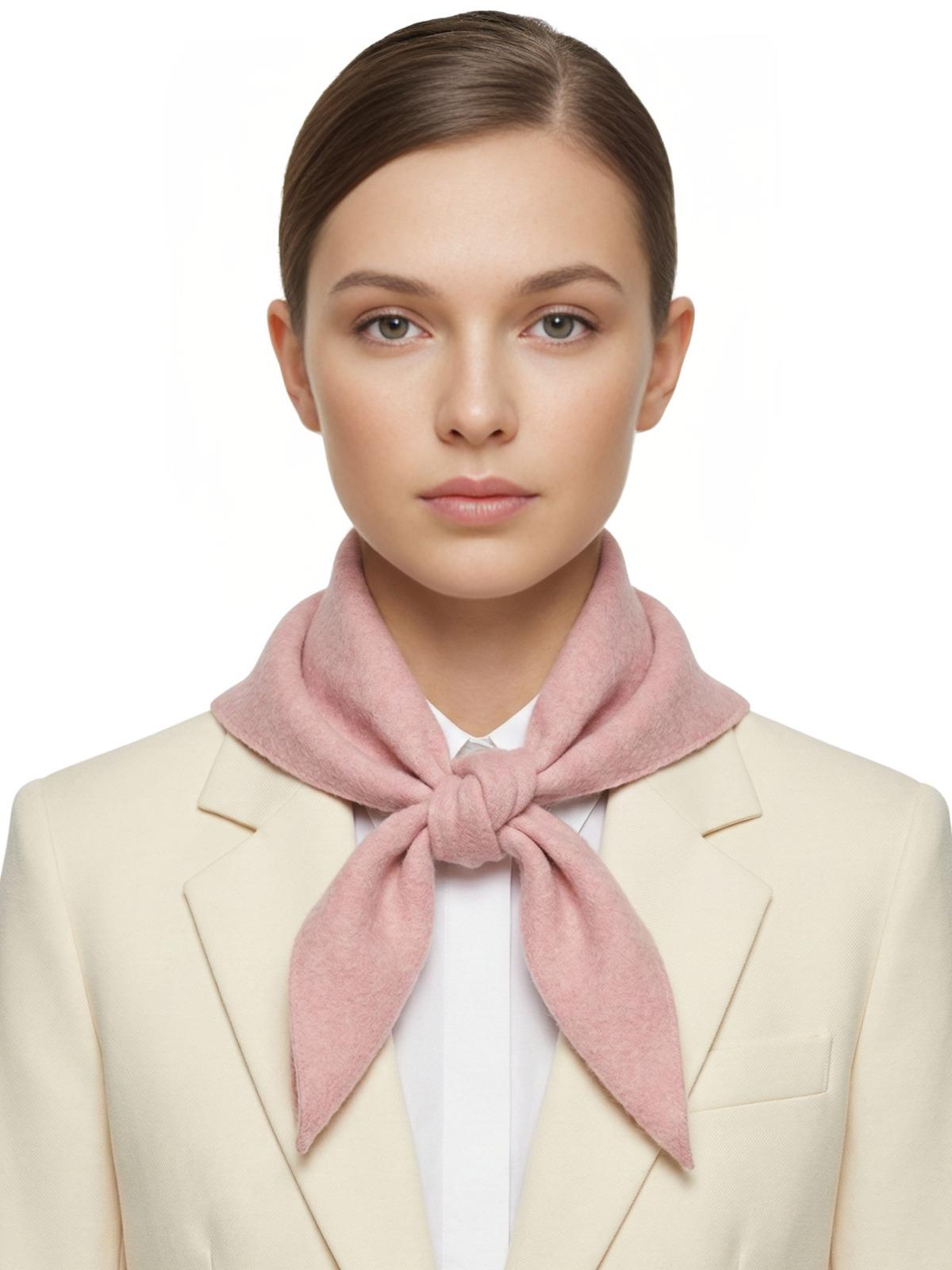 Woman wearing a pink wool scarf around her neck against a white background