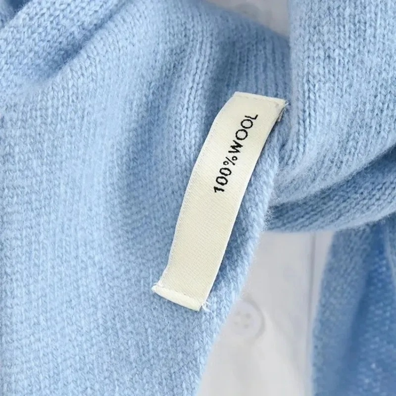 Close-up of blue fabric with a '100% Wool' label.