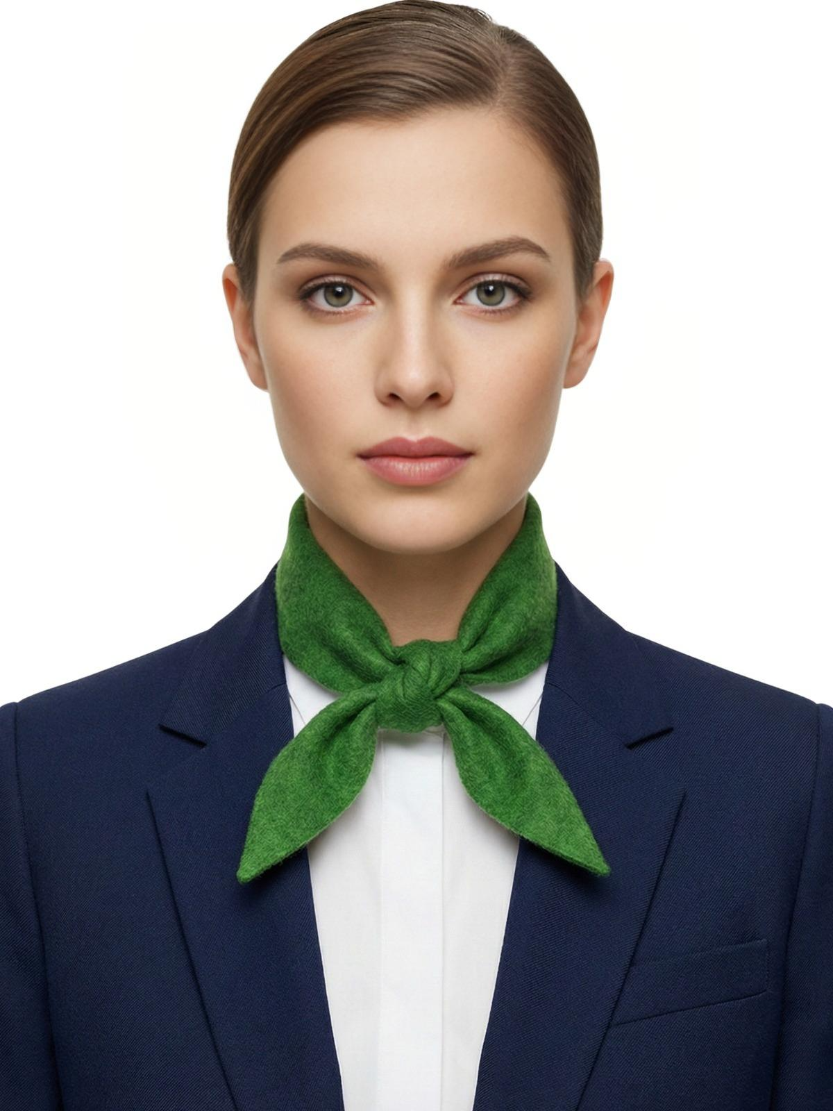 Woman wearing a green wool scarf around her neck with a white background