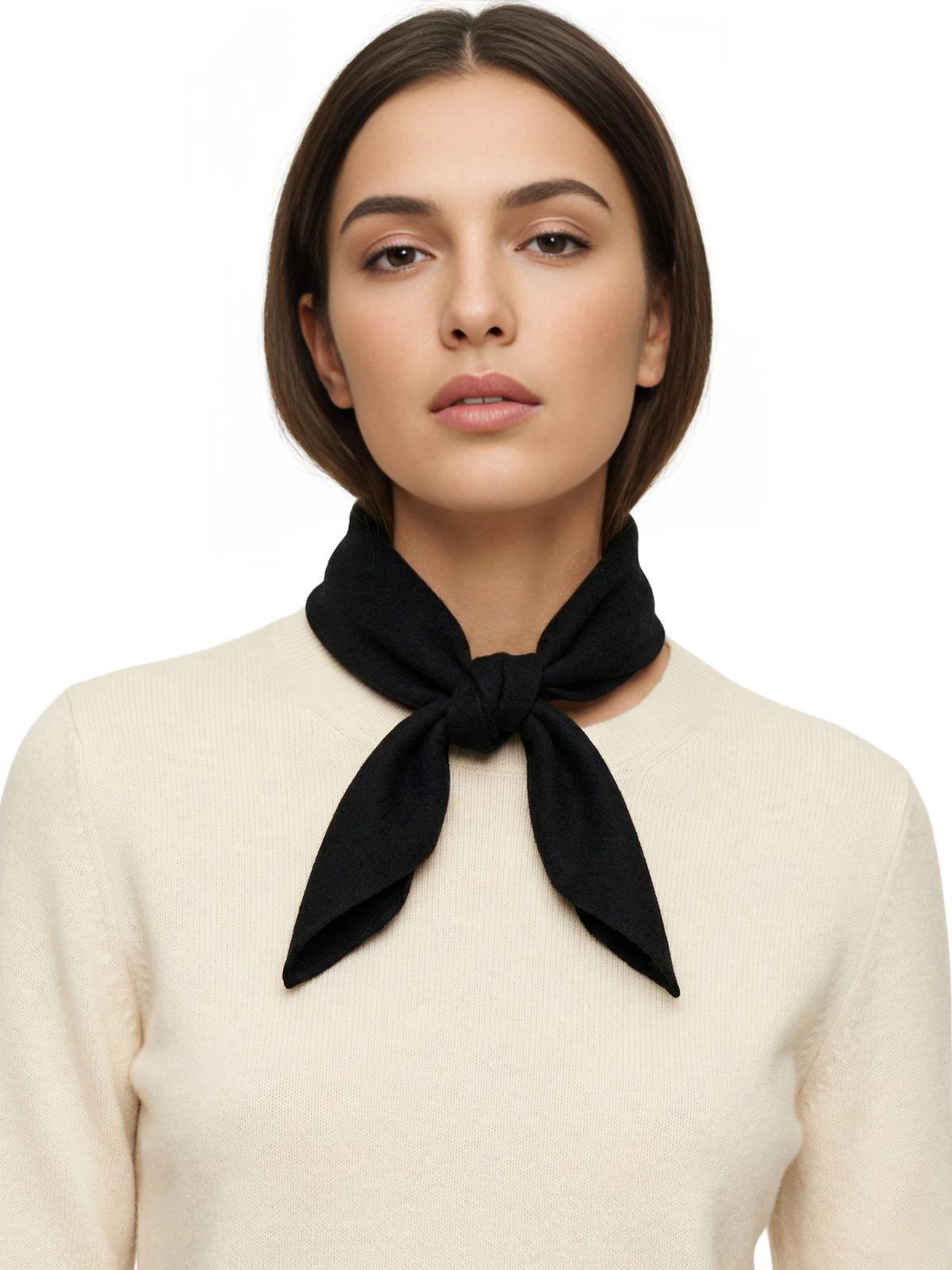 Woman wearing a black wool scarf around her neck against a white background