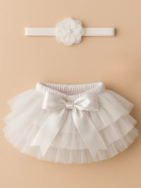 Thumbnail for White tutu skirt with bow and matching headband on a beige background