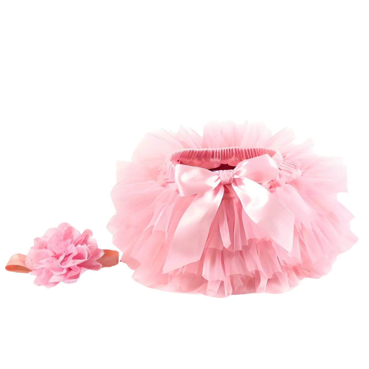 Pink tutu skirt and headband with a bow on a white background
