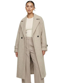 Thumbnail for Woman wearing a long beige oversized double breasted coat with pockets and turn down collar on a white background.