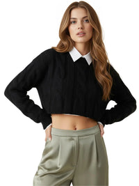 Thumbnail for Woman wearing a black crop sweater over a white shirt with beige pants on a white background