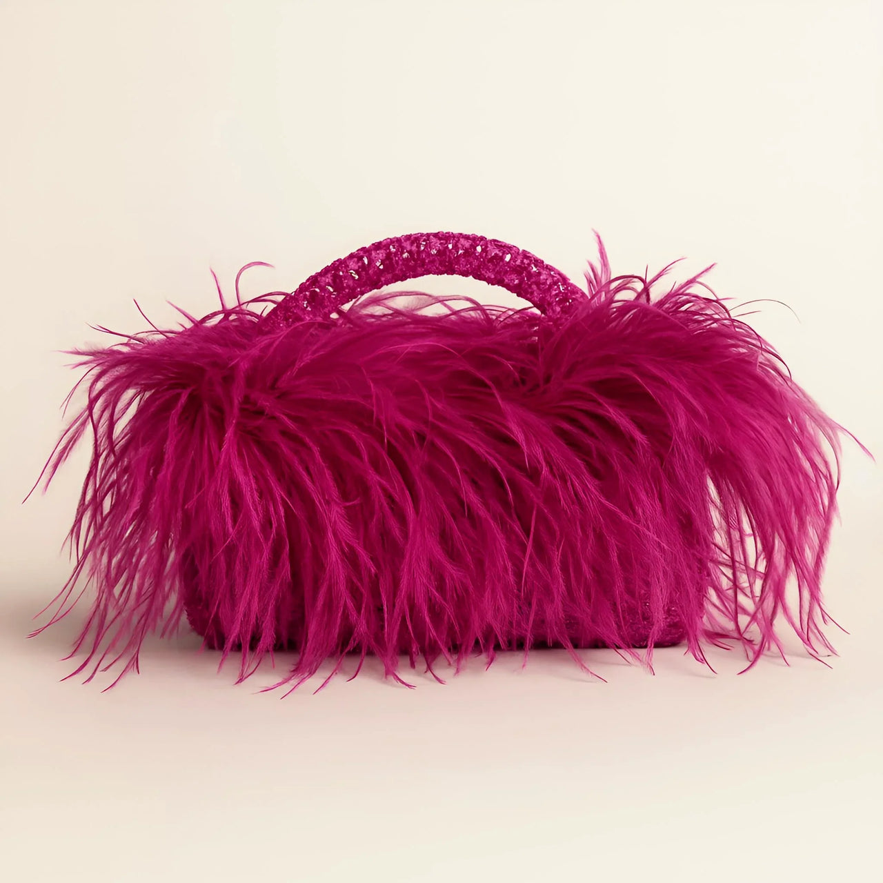 Pink ostrich feather handbag on a beige background