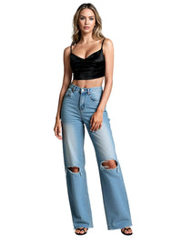 Thumbnail for Woman wearing a black crop top and light blue ripped jeans on a white background