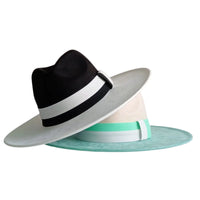 Thumbnail for Two fedora hats, one black with white brim, the other green with white brim, on a white background.