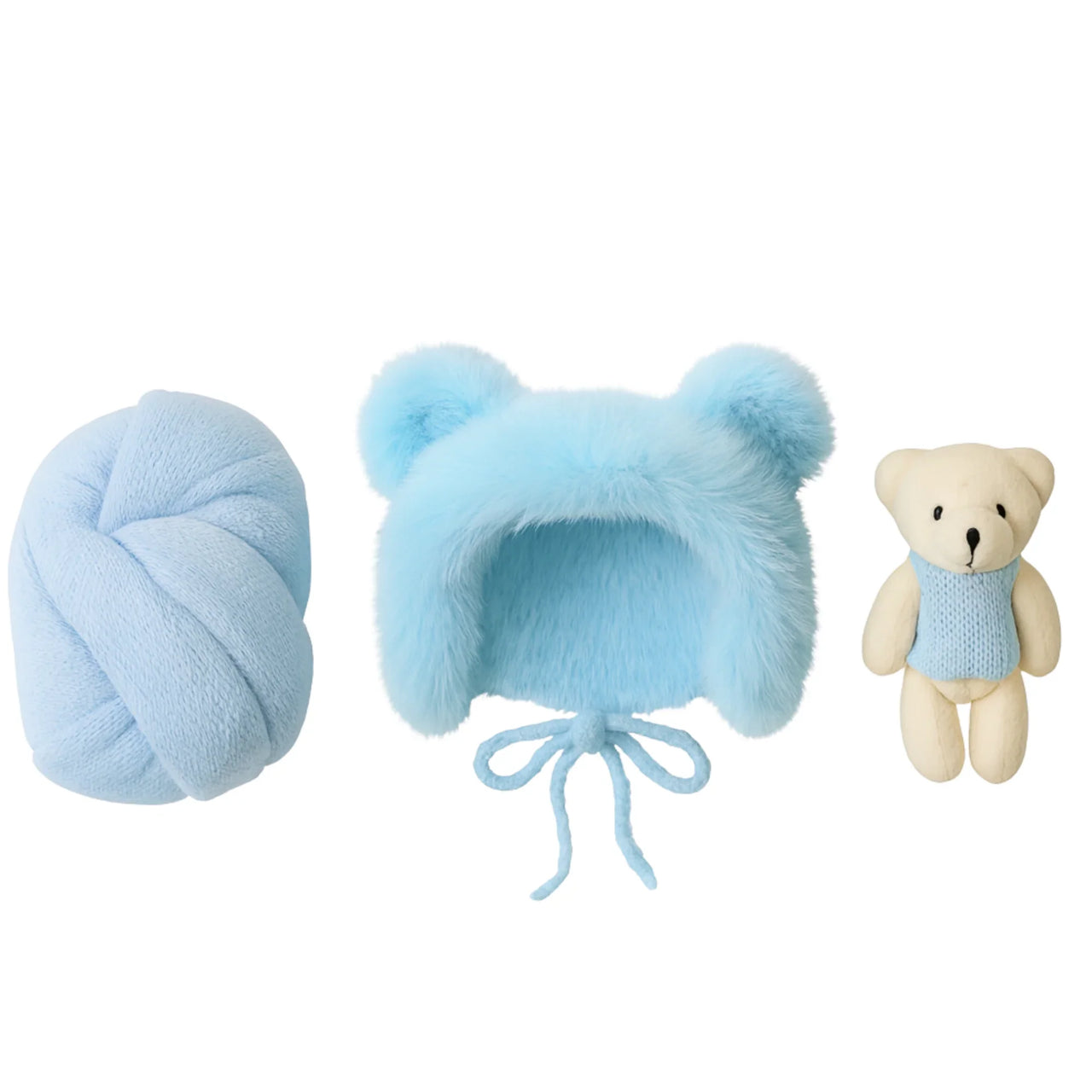 Set of blue baby hat, newborn wrap, and teddy bear on a white background