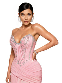 Thumbnail for Woman wearing a pink strapless dress with silver crystal embellishments on a white background