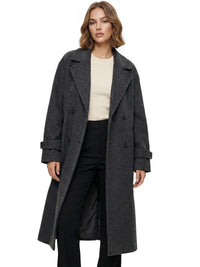 Thumbnail for Woman wearing a long dark grey oversized double breasted coat with pockets and turn down collar on a white background.