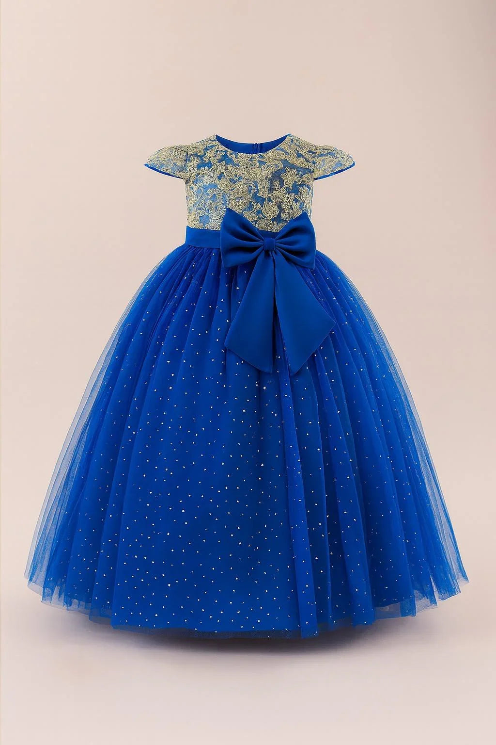 Blue dress with gold lace top and large bow on a beige background