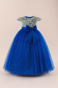 Thumbnail for Blue dress with gold lace top and large bow on a beige background