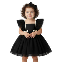Thumbnail for Child wearing a black dress with ruffled sleeves on a white background