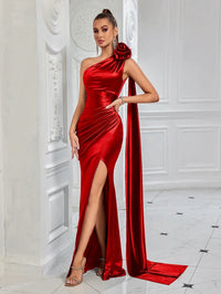 Thumbnail for Woman wearing a red satin one-shoulder gown with a high slit in a white room.
